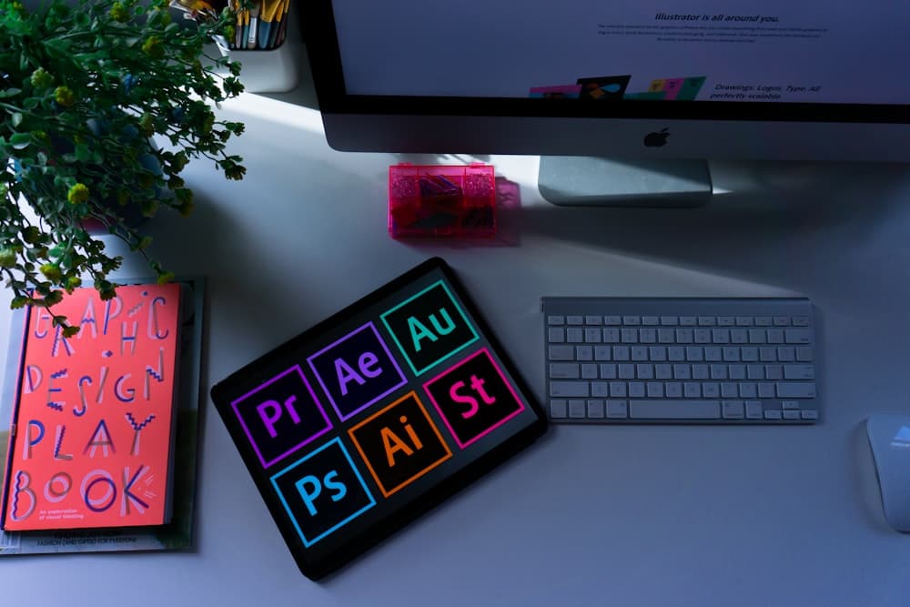 Designer working on brand identity layouts at a studio desk