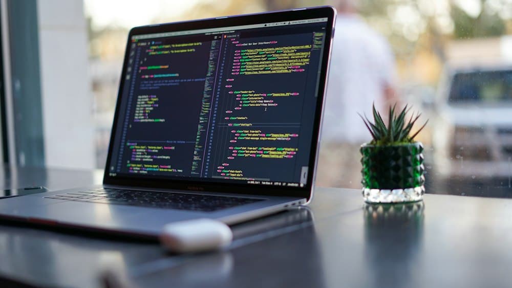 Developer writing code on a multi-monitor workstation